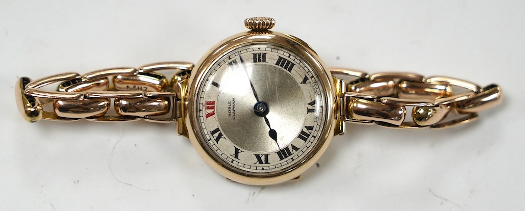 A lady's early 20th century 9ct gold manual wind wrist watch, with Arabic dial, on a 9ct expanding bracelet, gross weight 21.7 grams. Condition - fair to good
